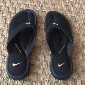 Nike black with white logo flip flop.